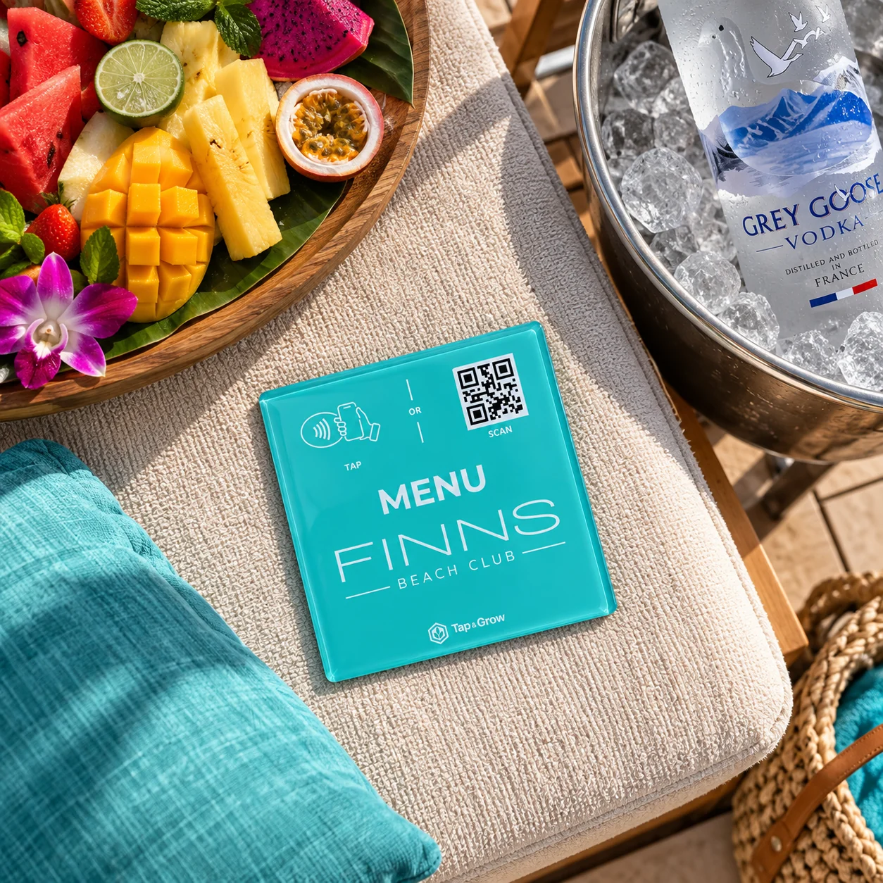 Illustrative FINNS menu NFC plaque concept on a beach bed